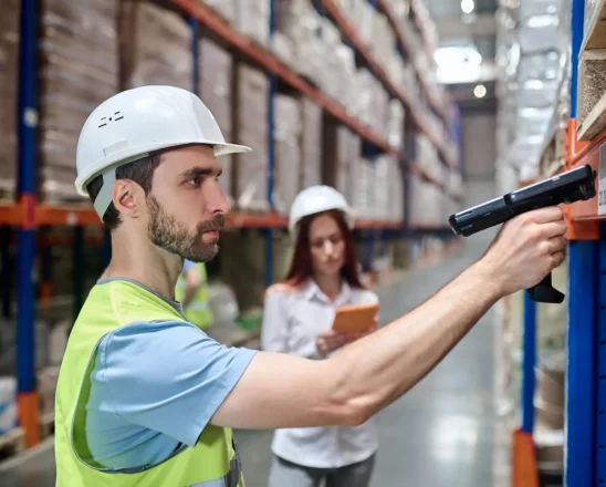 man-scanning-barcode-from-cargo-woman-with-tablet